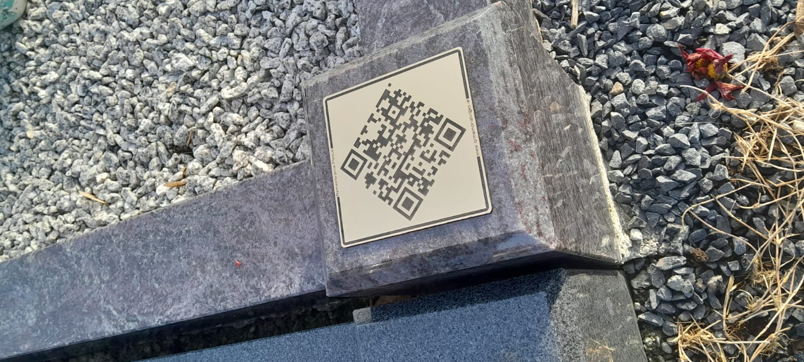 Memorial plaque displayed at a grave